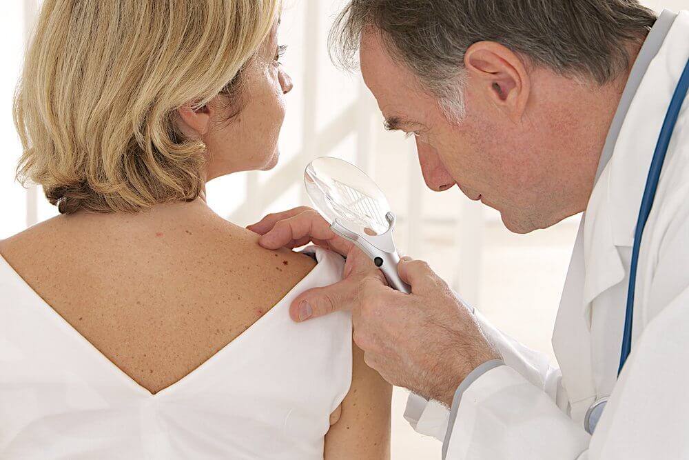 Doctor checking a woman's skin