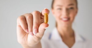 Woman-Holding-Pill-Vitamin