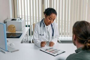 Doctor interviewing patient with migraine