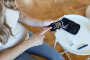 Woman measuring her blood sugar. Diabetes Alert Day