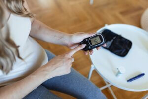 Woman measuring her blood sugar. Diabetes Alert Day 