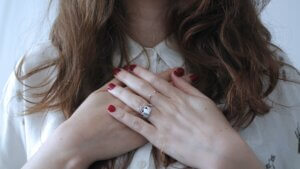 woman holding her hands above her heart