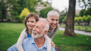 middle-aged couple and their grandchild playing and smiling