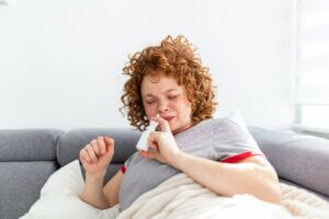 woman using nasal spray 