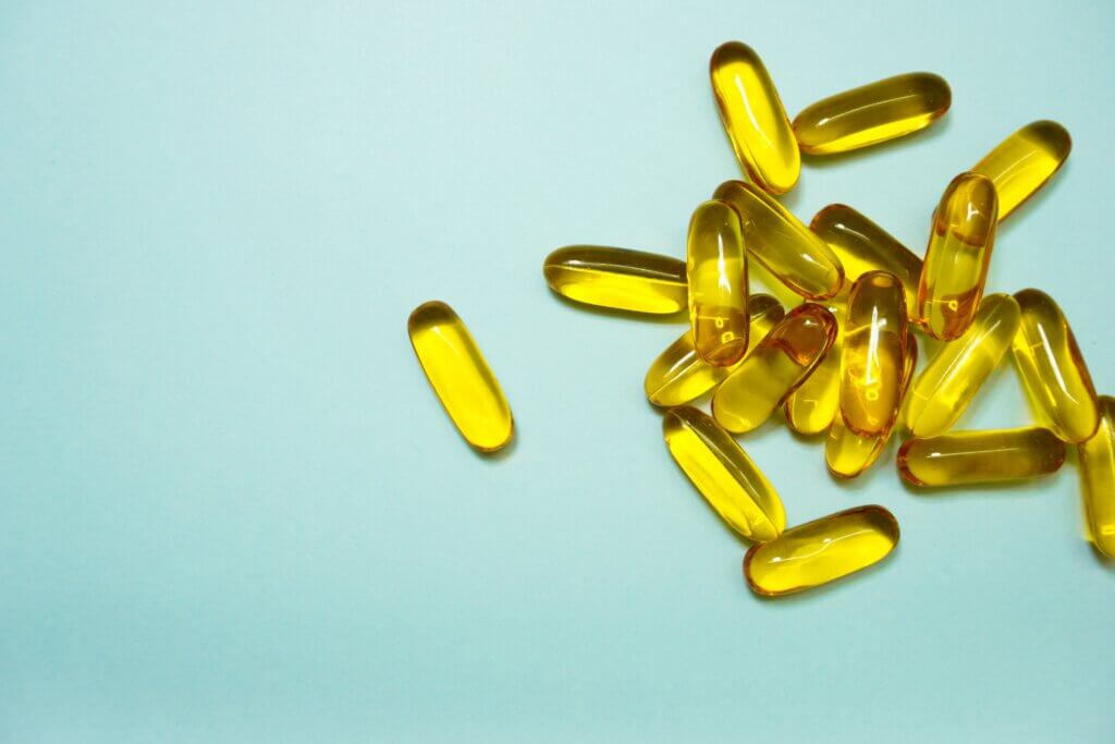 yellow medicine tablets on a aqua background