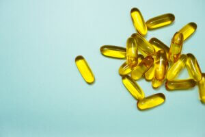yellow medicine tablets on a aqua background