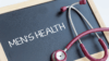 Stethoscope next to a chalk board with the words Men's Health