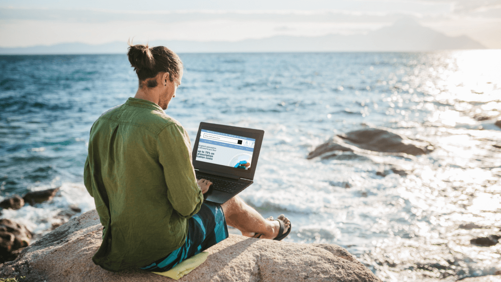 Young digital nomad man working by the sea