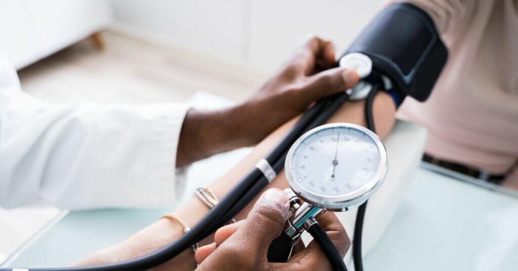 Doctor's Hand Checking Blood Pressure