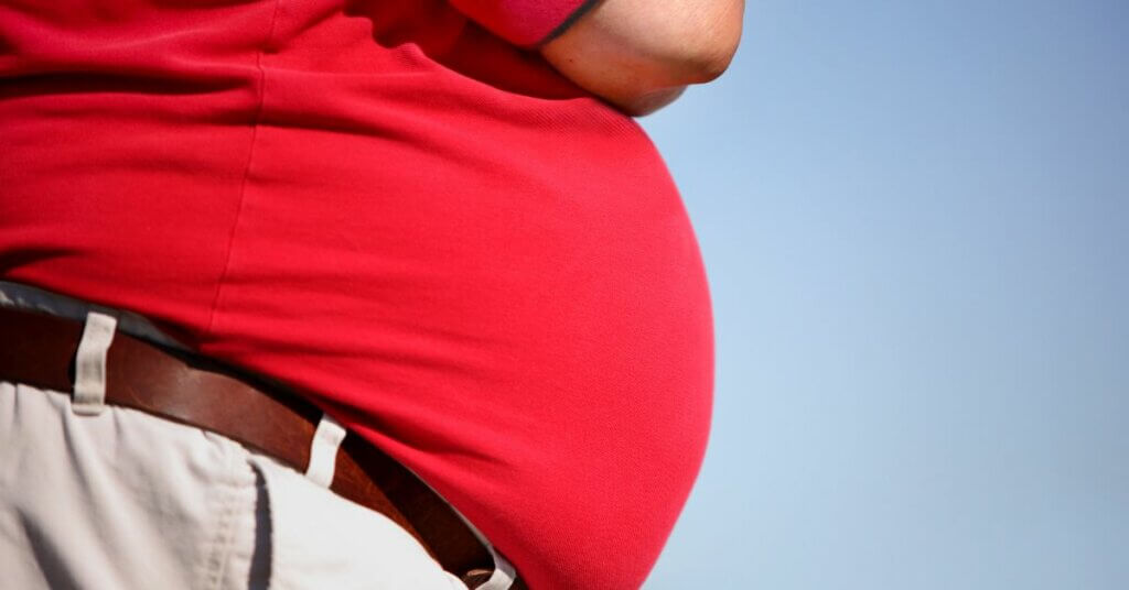 Person in red short with overweight stomach