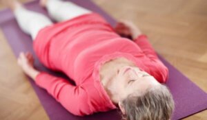 Woman laying on yoga mat
