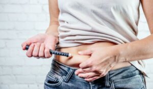 A Woman Injects Insulin with Insulin Injection Device into the Subcutaneous Tissue of Abdomen