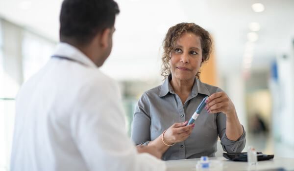 doctor showing Ozempic to patient