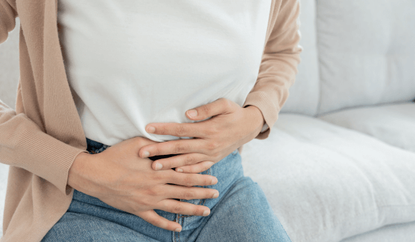 IBS/GERD image Hurt woman touch belly stomach ache painful