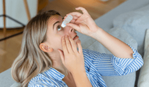 Woman using eye drop, woman dropping eye lubricant to treat dry eye