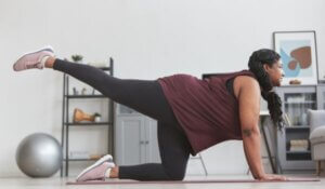 Woman stretching in gym clothes