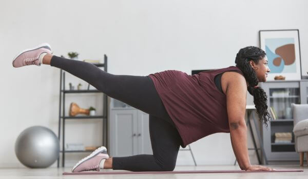 Woman stretching in gym clothes