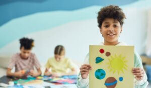 A Boy Holding his Art Project