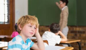 Cute pupil not paying attention in classroom