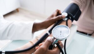 Doctor's Hand Checking Blood Pressure