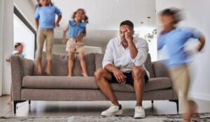 Father with Kids Running, Jumping and Playing in Home or House Living Room.