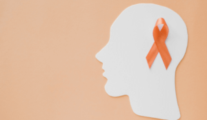 Orange ribbon on paper head brain on orange background, Attention deficit hyperactivity disorder ADHD awareness,