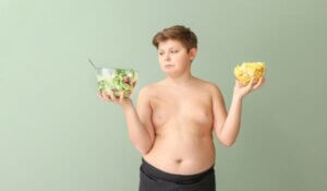 Overweight Boy Choosing between Salad and Chips