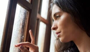 Thinking, Lonely and Woman in Window by Rain, Winter Weather and Water with Drops for Gloomy