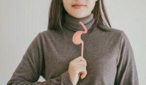 Woman hands holding stomach, heartburn, Gastroesophageal reflux disease (GERD) or acid reflux symptom, health care concept