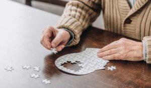 cropped view of senior man playing with puzzles