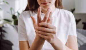 massage hand with wrist pain, rheumatoid arthritis concept.