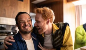 Man with Down Syndrome Laughing with Friend