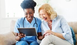 Nurse Helping senior use Tablet Technology