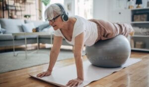 Senior woman exercising pilates at home