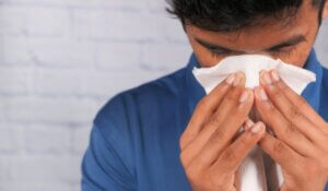 Sick Man with Flu Allergy Sneezing and Blowing Nose