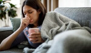 Woman coughing on couch