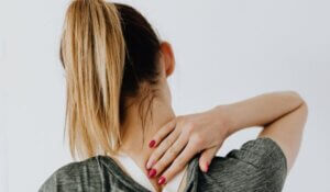 Back View of a Woman Having a Neck Pain