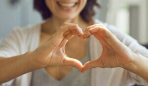 Happy Smiling Lady Showing Heart Symbol with Her Hands