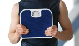 Man Holding Weighing Scale