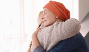 Patient centered care - Woman with cancer being hugged
