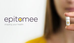 Woman holding epitomee capsule