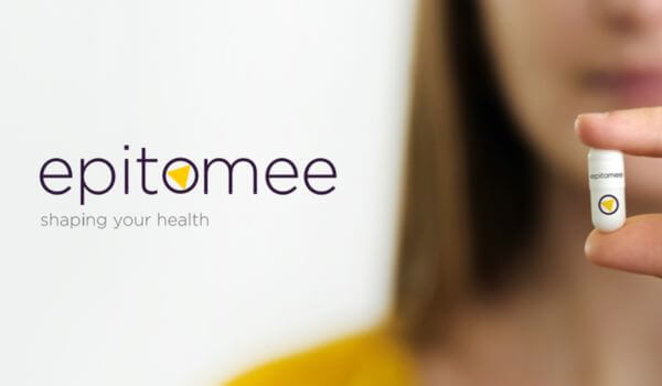 Woman holding epitomee capsule