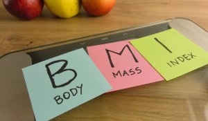 Handwritten acronym BMI on bathroom scale