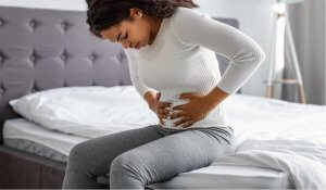 Woman Touching Her Tummy Suffering from Endometriosis