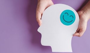 hands holding smile face in brain paper cut, happy smiley emotion - Dopamine concept