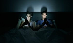 Scrolling on your phone before bed with your partner can damage your sleep