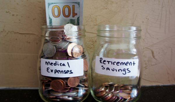 Jars with cash showing how the cost of medications for chronic conditions impacts on savings